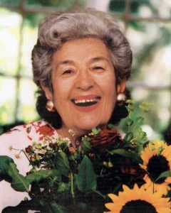 Woman with flowers and green background.
