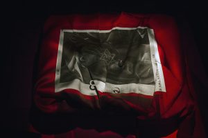 Black background with red fabric and black and white image.