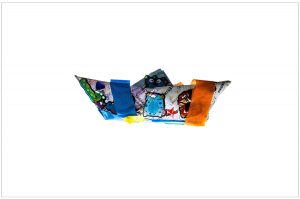 Blue, white, and orange origami boat with children's stickers.