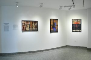 Installation view of three photographs with black frames, figure, heart and seismic register lines.