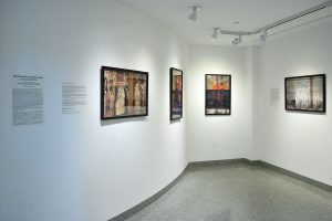 Installation view of four photographs with black frames, figure, heart and seismic register lines.